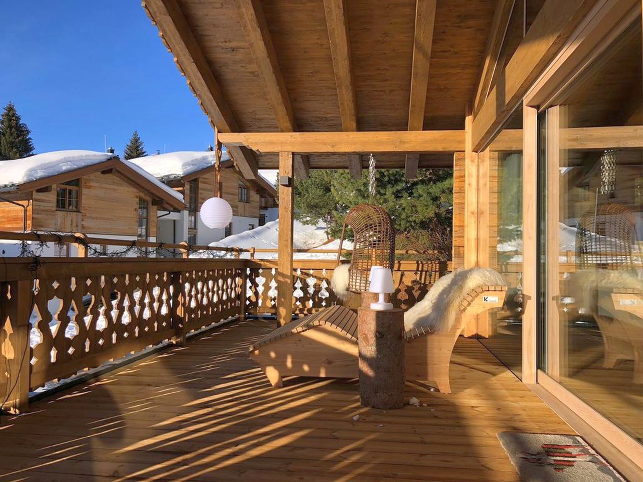 Hot tub on flagstone patio overlooks water and mountains.